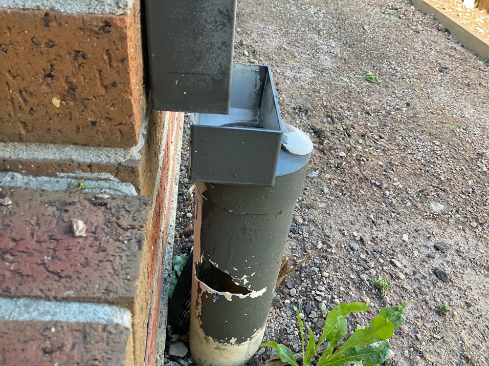 Downpipe discharging onto the ground rather than into the system, recorded during a pre-purchase inspection in Point Cook